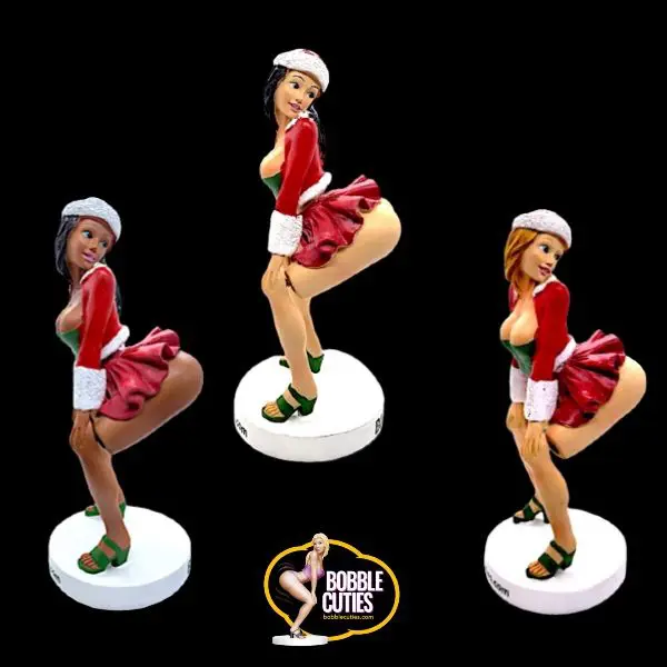 Three figurines of a woman in red and white outfits.